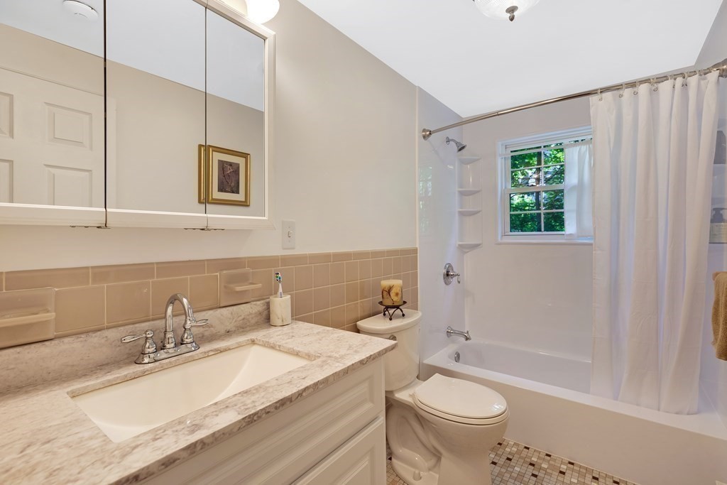 14 Walker Road, Unit 6 North Andover, MA 01845 - Photo 13 of 21 a bathroom with a granite countertop sink mirror vanity and toilet
