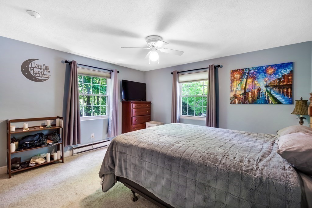 14 Walker Road, Unit 6 North Andover, MA 01845 - Photo 15 of 21 a bedroom with a bed and a tv on the dresser