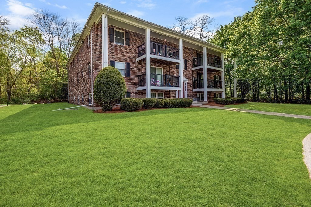 14 Walker Road, Unit 6 North Andover, MA 01845 - Photo 21 of 21 a view of an apartment with a big yard and large trees