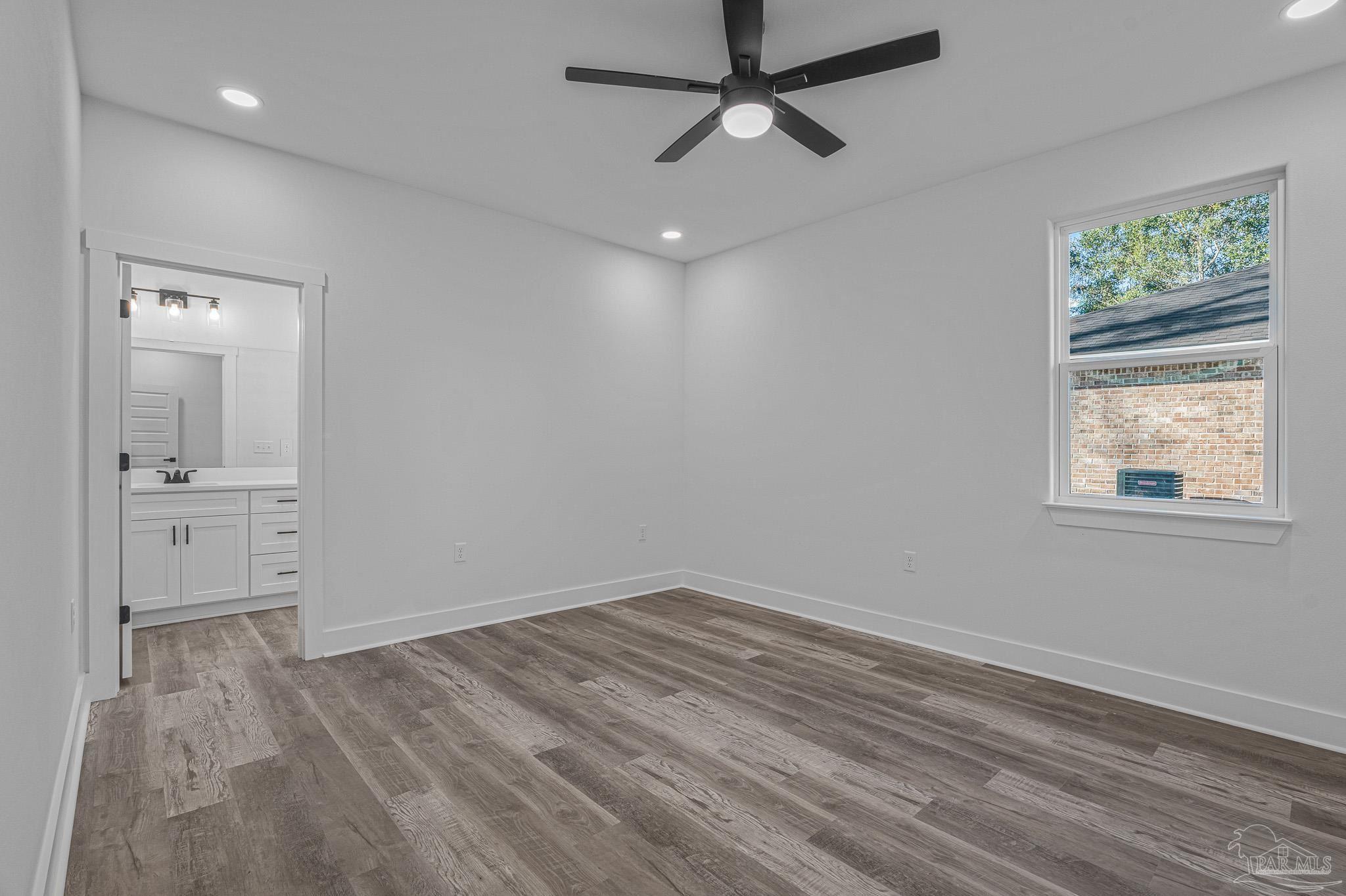 5005 Saufley Field Road Pensacola, FL 32526 - Photo 9 of 27 wooden floor in an empty room with a window