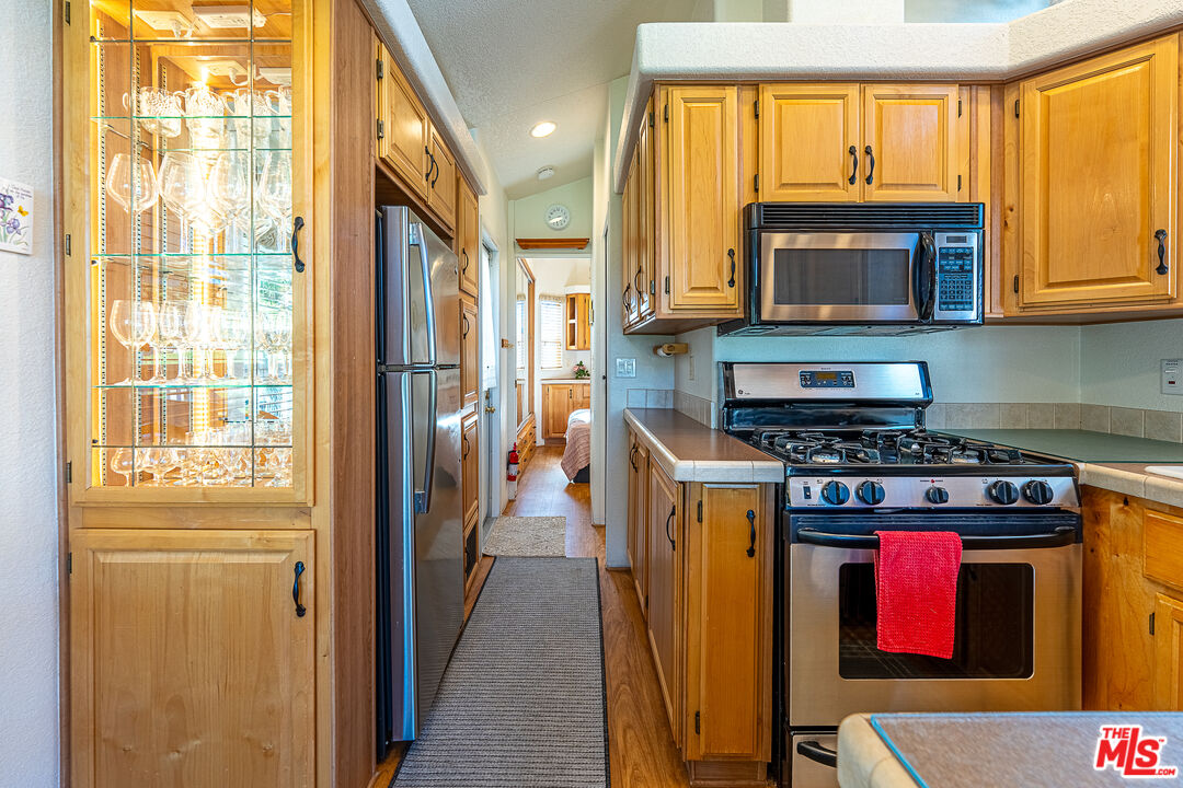 70200 Dillon Road, Unit 581 Desert Hot Springs, CA 92241 - Photo 12 of 23 a kitchen with stainless steel appliances granite countertop a refrigerator and a stove