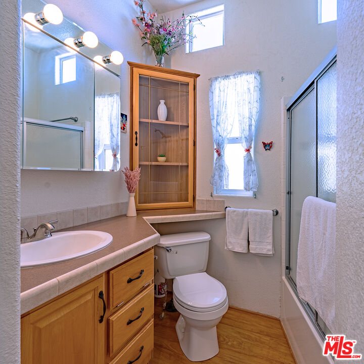 70200 Dillon Road, Unit 581 Desert Hot Springs, CA 92241 - Photo 13 of 23 a bathroom with a sink a toilet and shower