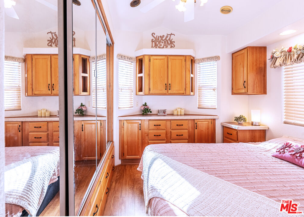 70200 Dillon Road, Unit 581 Desert Hot Springs, CA 92241 - Photo 15 of 23 a bedroom with a bed and a view of living room