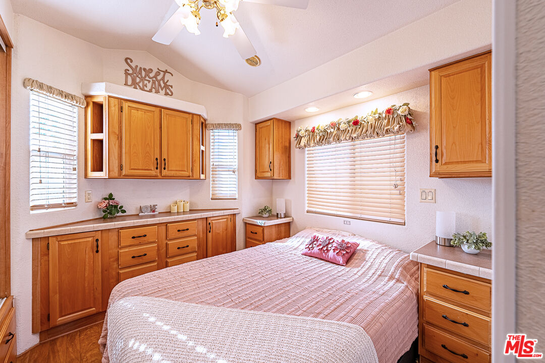 70200 Dillon Road, Unit 581 Desert Hot Springs, CA 92241 - Photo 16 of 23 a bedroom with a bed and a dresser