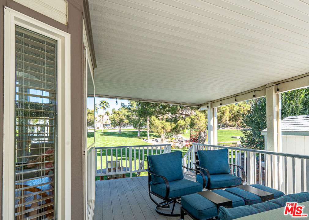 70200 Dillon Road, Unit 581 Desert Hot Springs, CA 92241 - Photo 2 of 23 a balcony with chairs and table