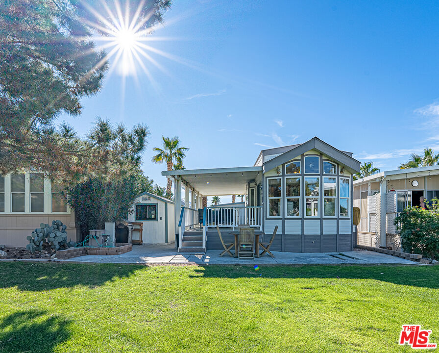 70200 Dillon Road, Unit 581 Desert Hot Springs, CA 92241 - Photo 23 of 23 a view of a house with a yard
