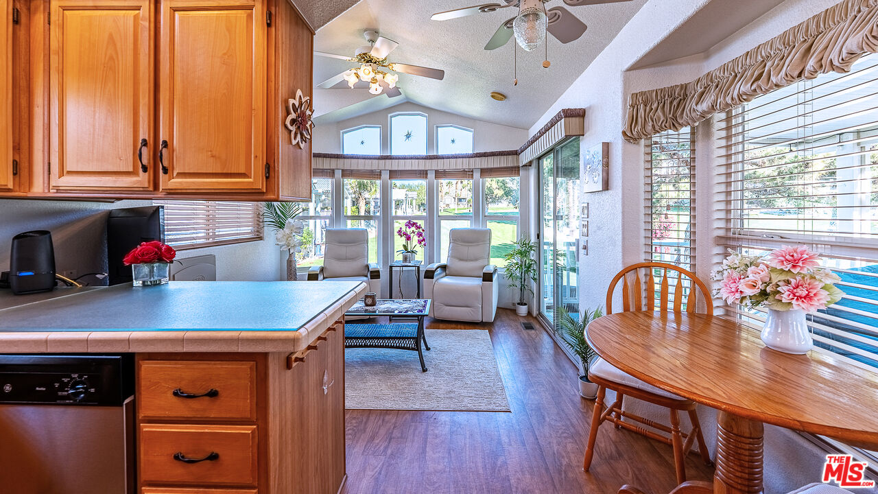 70200 Dillon Road, Unit 581 Desert Hot Springs, CA 92241 - Photo 6 of 23 a view of a dining room with furniture window and wooden floor