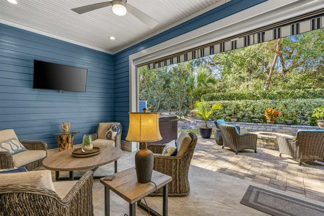 a view of a patio with couches table and chairs and potted plants