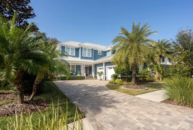 a front view of a house with outdoor seating and plants