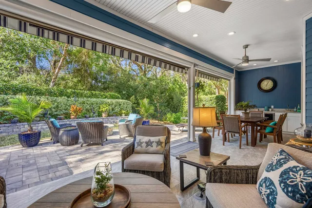 a view of a patio with table and chairs and potted plants