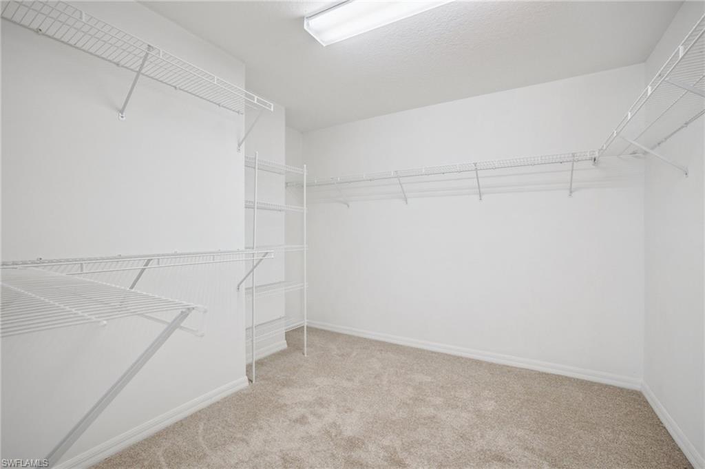 5348 Cypress Lane Naples, FL 34113 - Photo 16 of 28 a view of storage and utility room with racks on the wall