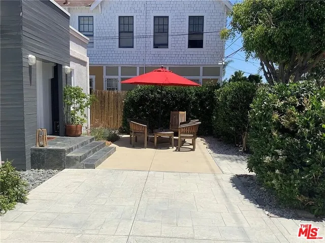 a backyard of a house with yard and outdoor seating
