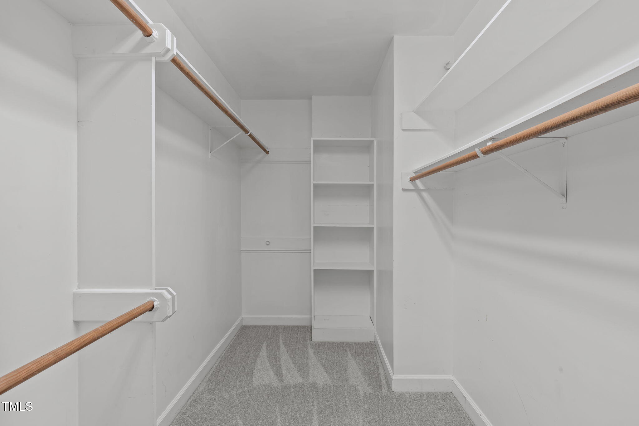 6016 Heatherstone Drive Raleigh, NC 27606 - Photo 22 of 40 a view of walk in closet with empty racks