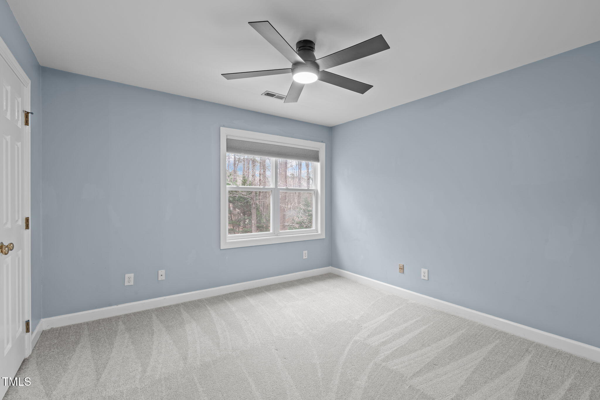 6016 Heatherstone Drive Raleigh, NC 27606 - Photo 23 of 40 an empty room with a ceiling fan and window