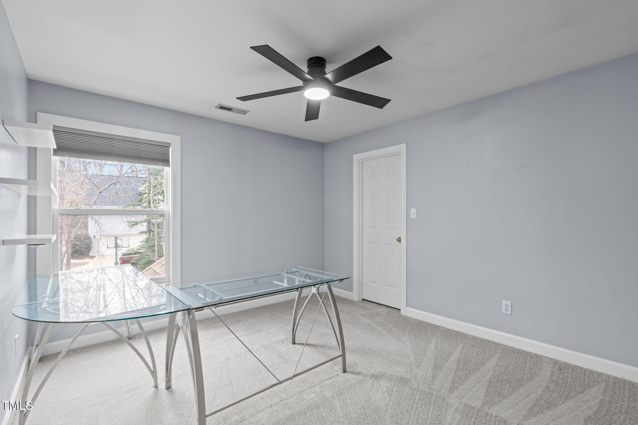 6016 Heatherstone Drive Raleigh, NC 27606 - Photo 25 of 40 a room with window and ceiling fan