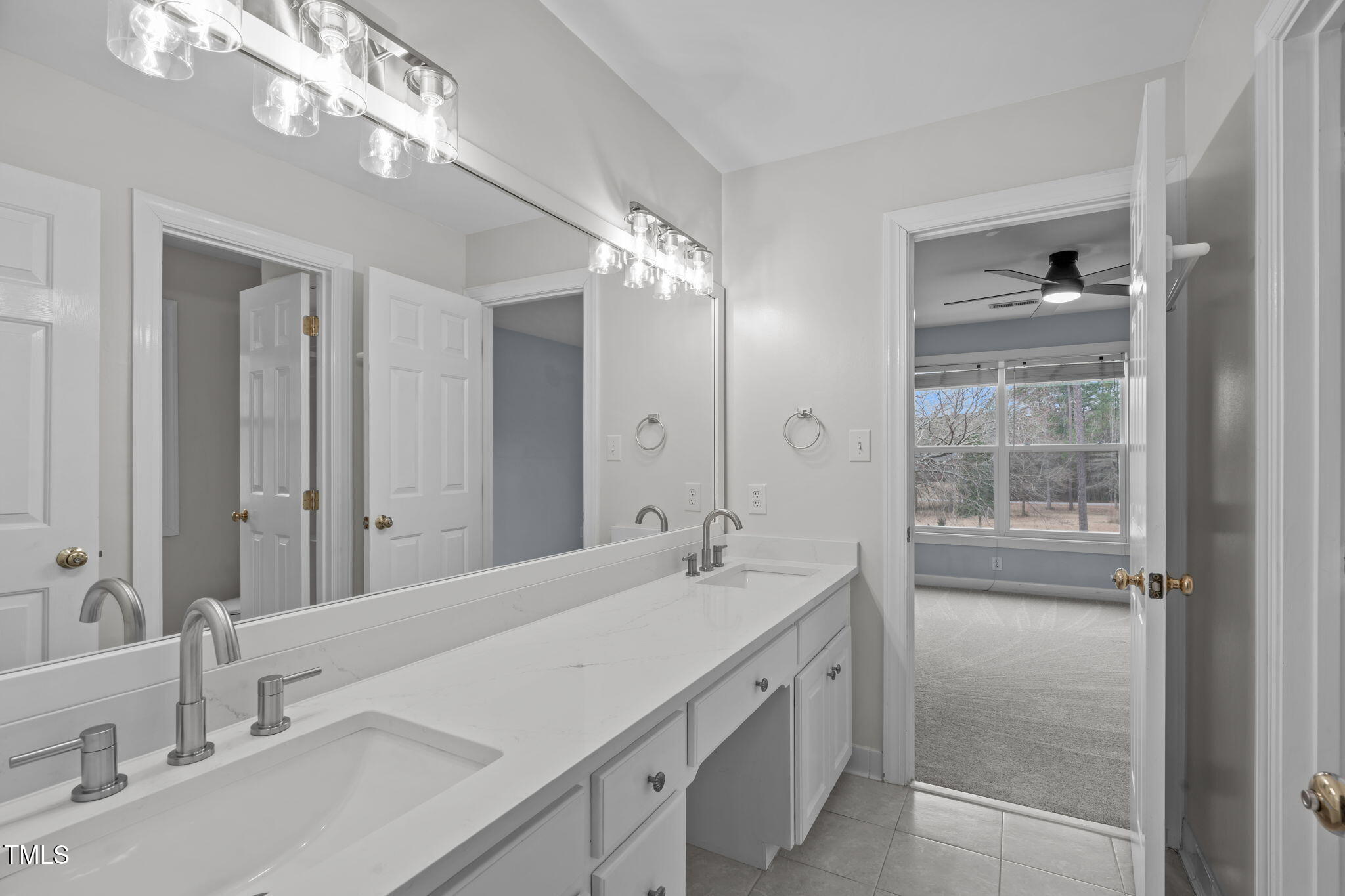 6016 Heatherstone Drive Raleigh, NC 27606 - Photo 26 of 40 a bathroom with a sink double vanity and shower