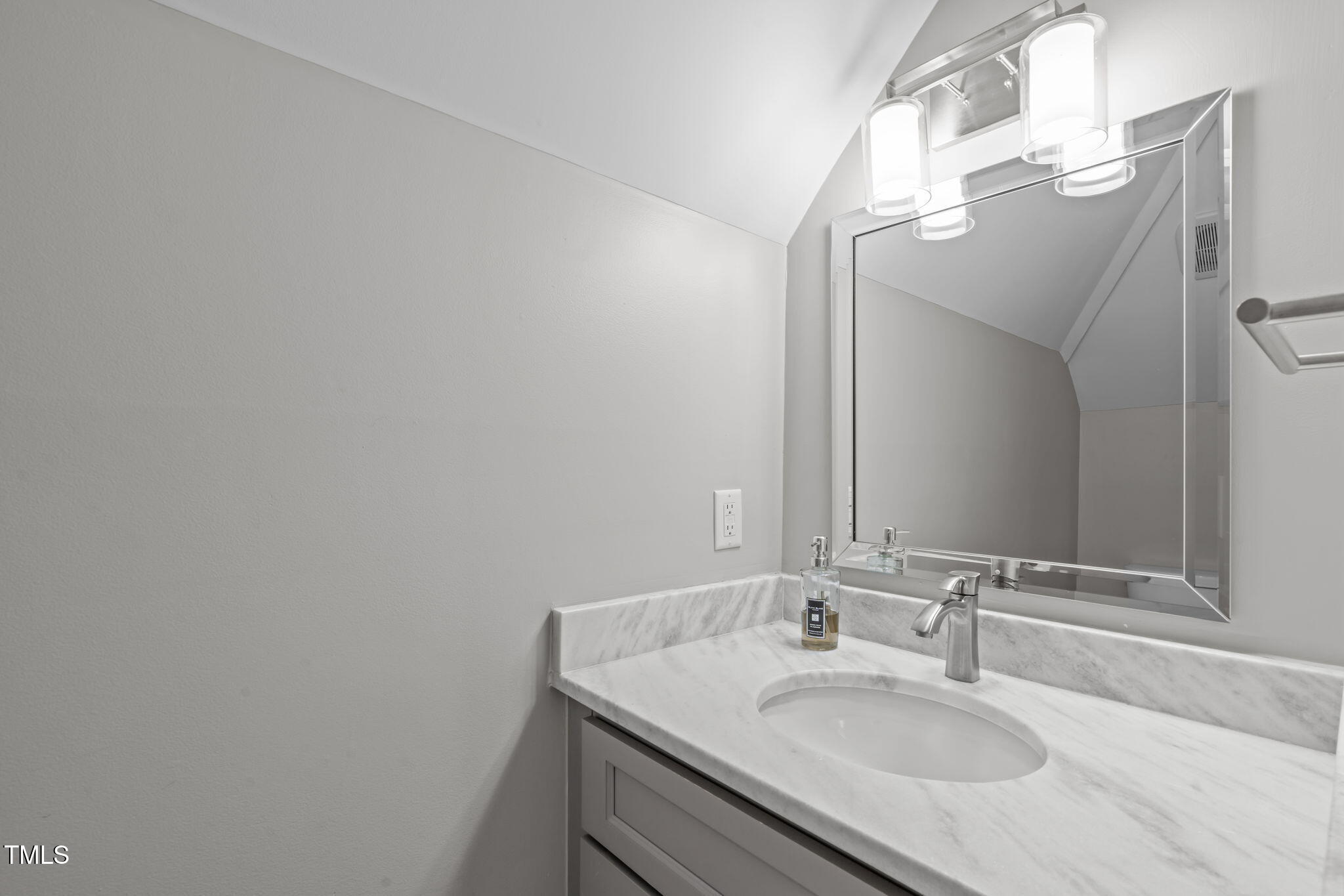 6016 Heatherstone Drive Raleigh, NC 27606 - Photo 30 of 40 a bathroom with a sink and a mirror