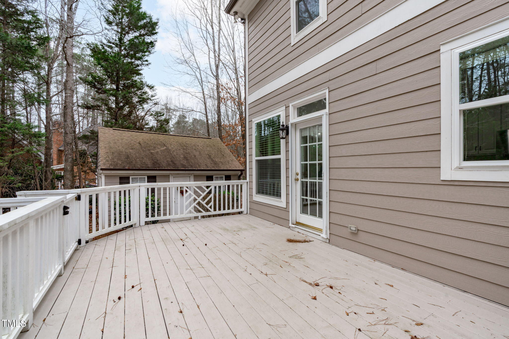 6016 Heatherstone Drive Raleigh, NC 27606 - Photo 32 of 40 a view of a house with wooden deck and a backyard