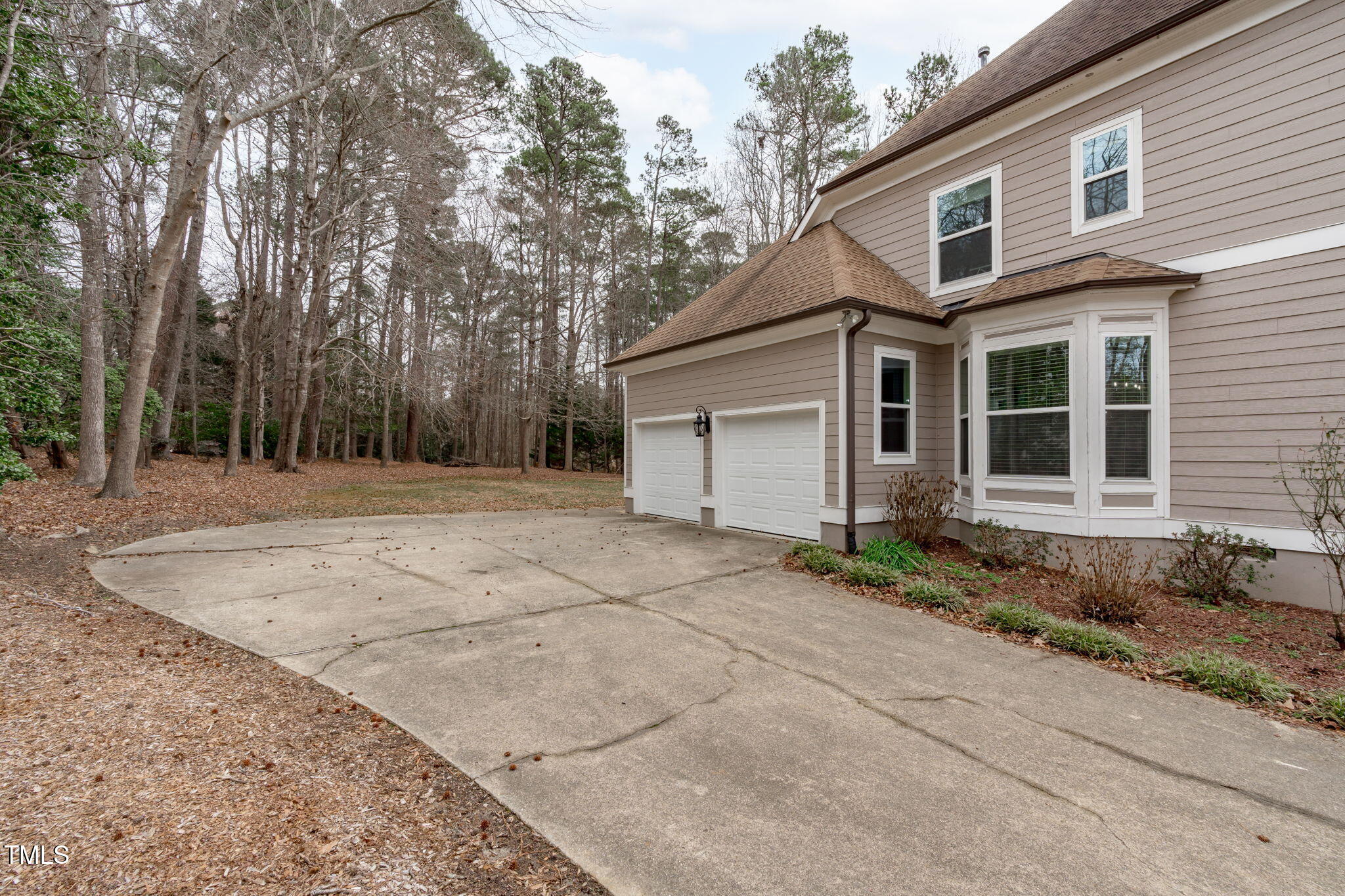 6016 Heatherstone Drive Raleigh, NC 27606 - Photo 37 of 40 a house with trees in front of it