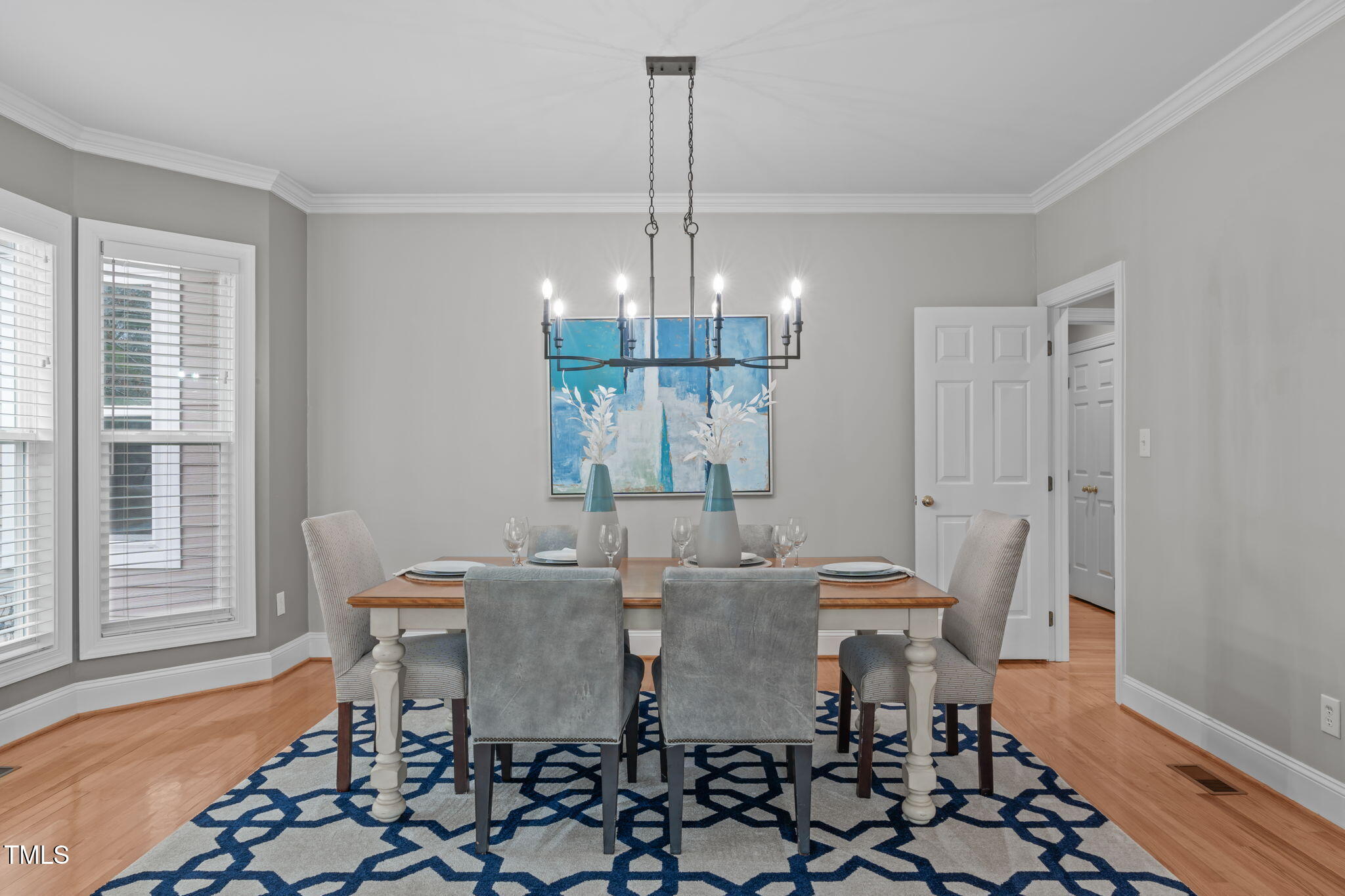 6016 Heatherstone Drive Raleigh, NC 27606 - Photo 7 of 40 a view of a dining room with furniture wooden floor and chandelier
