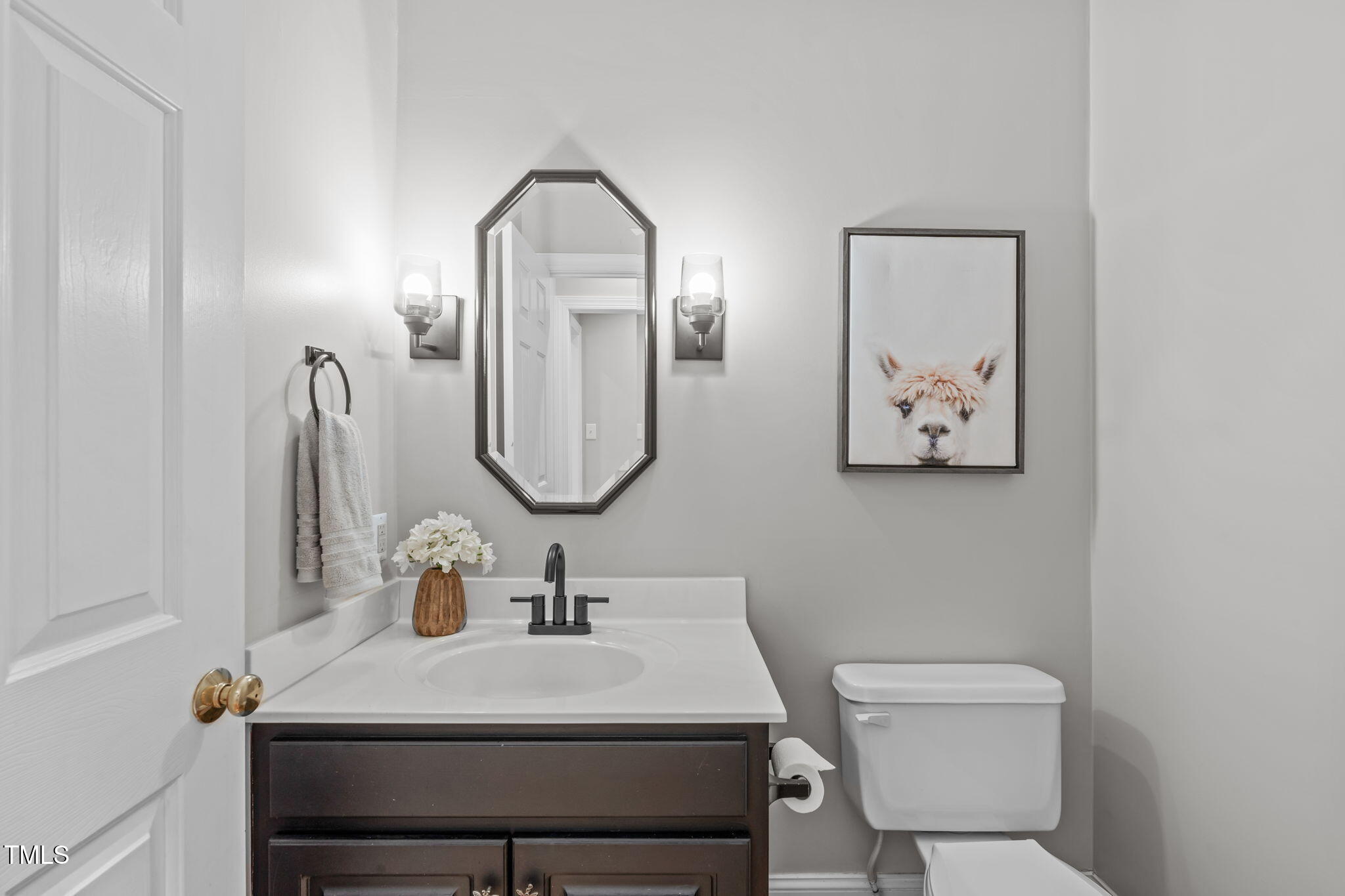6016 Heatherstone Drive Raleigh, NC 27606 - Photo 8 of 40 a bathroom with a toilet a sink and mirror