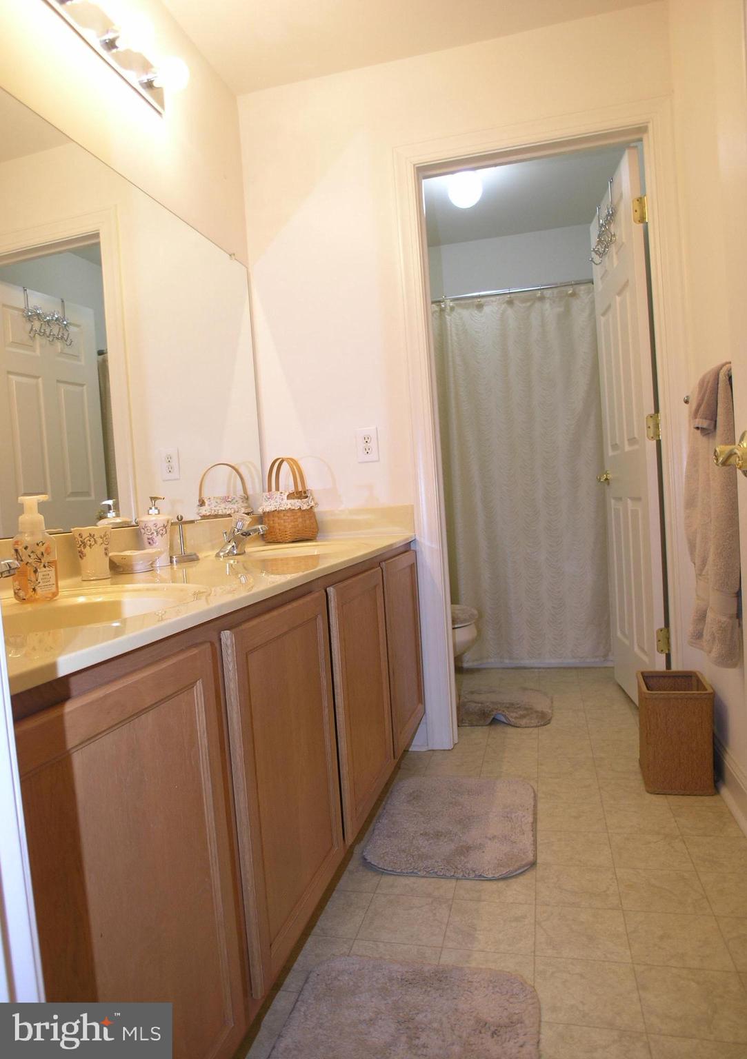 118 Casey Lane Bensalem, PA 19020 - Photo 11 of 26 a bathroom with a sink a mirror and a shower
