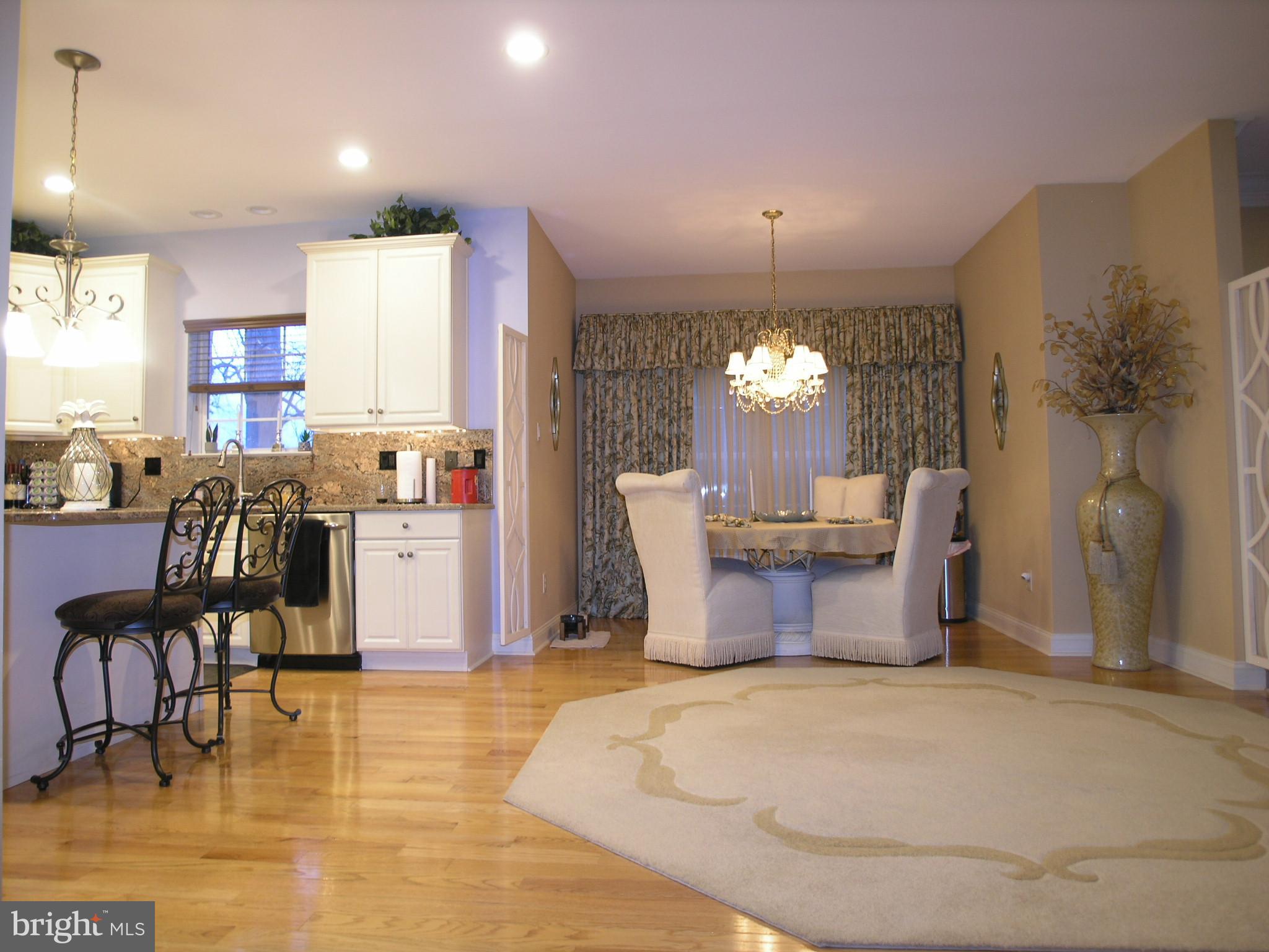 118 Casey Lane Bensalem, PA 19020 - Photo 5 of 26 a living room with furniture a dining table and a chandelier