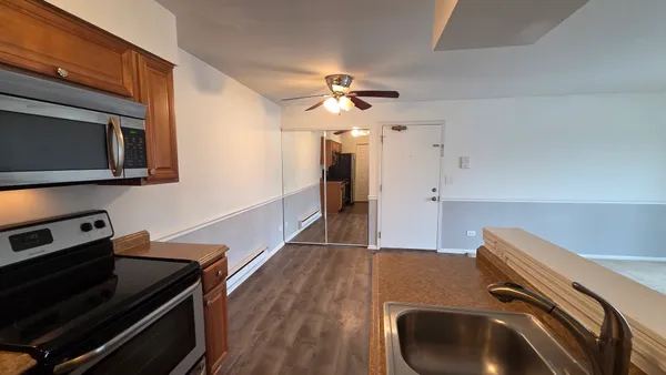 a kitchen with a sink appliances and cabinets