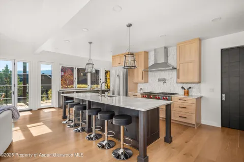 a kitchen with appliances a sink and cabinets