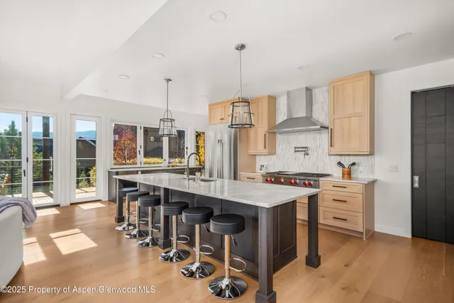 a kitchen with appliances a sink and cabinets