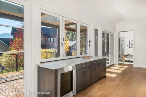 a large living room with stainless steel appliances granite countertop a stove and a large window