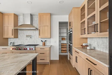 a kitchen with a stove oven and sink