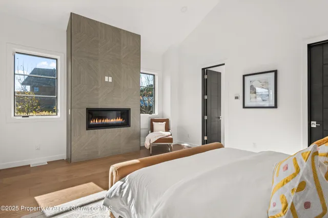 a bedroom with a bed and a painting on the wall