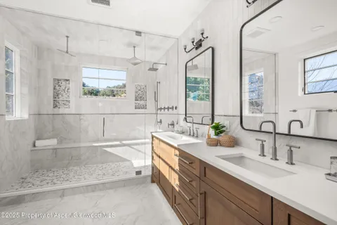 a bathroom with a double vanity sink mirror and double