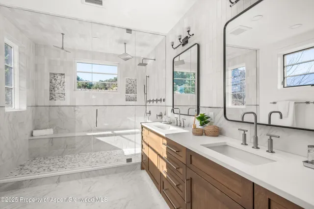 a bathroom with a double vanity sink mirror and double