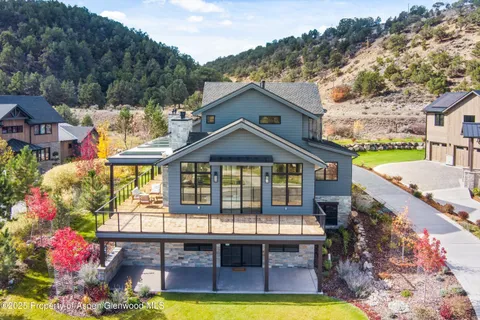 a view of a house with swimming pool and a yard
