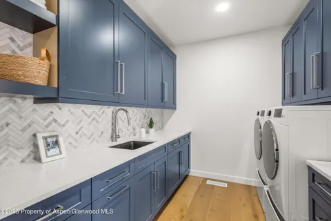 a view of empty room with wooden floor and window