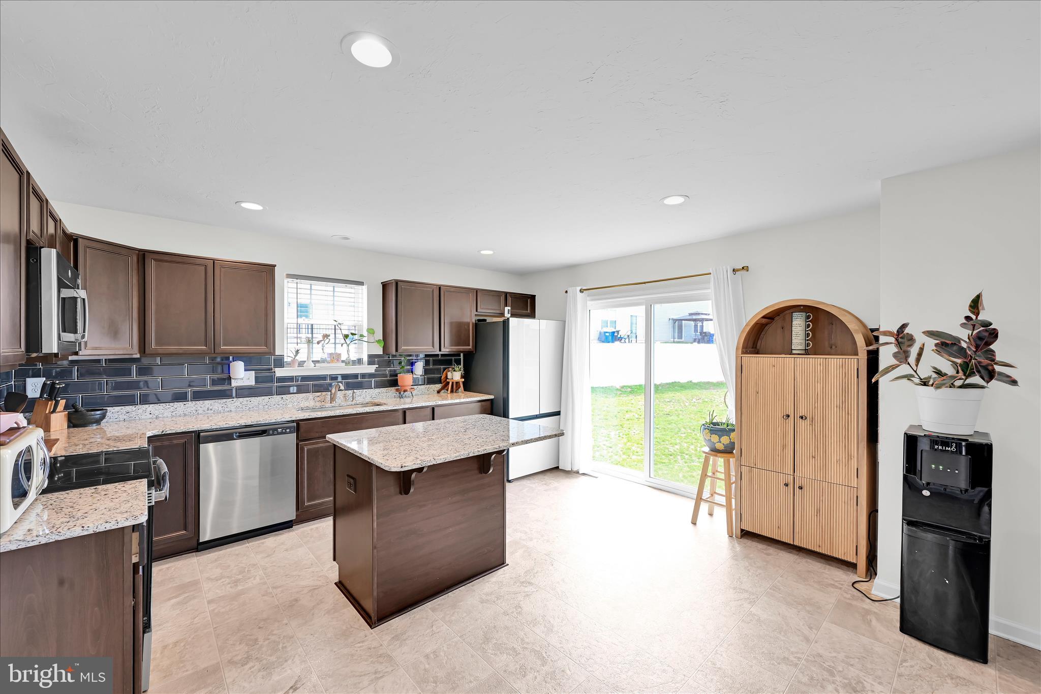 2625 Village Road Dover, PA 17315 - Photo 5 of 15 a large kitchen with kitchen island a sink white cabinets and stainless steel appliances