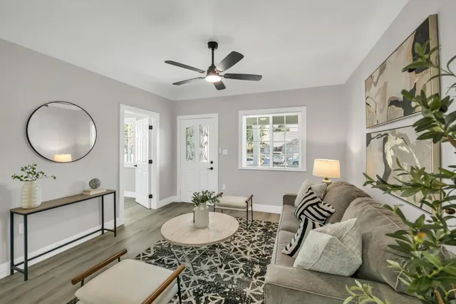 a living room with furniture flowerpot and window
