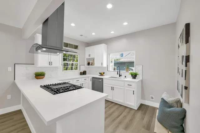 a kitchen with a stove and white cabinets