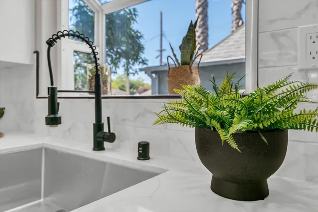 a view of a house with a yard and large tree