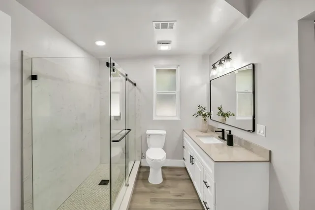 a view of a house with a tree on the road