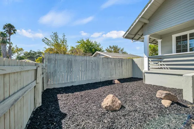 a living room with furniture a rug and a chandelier