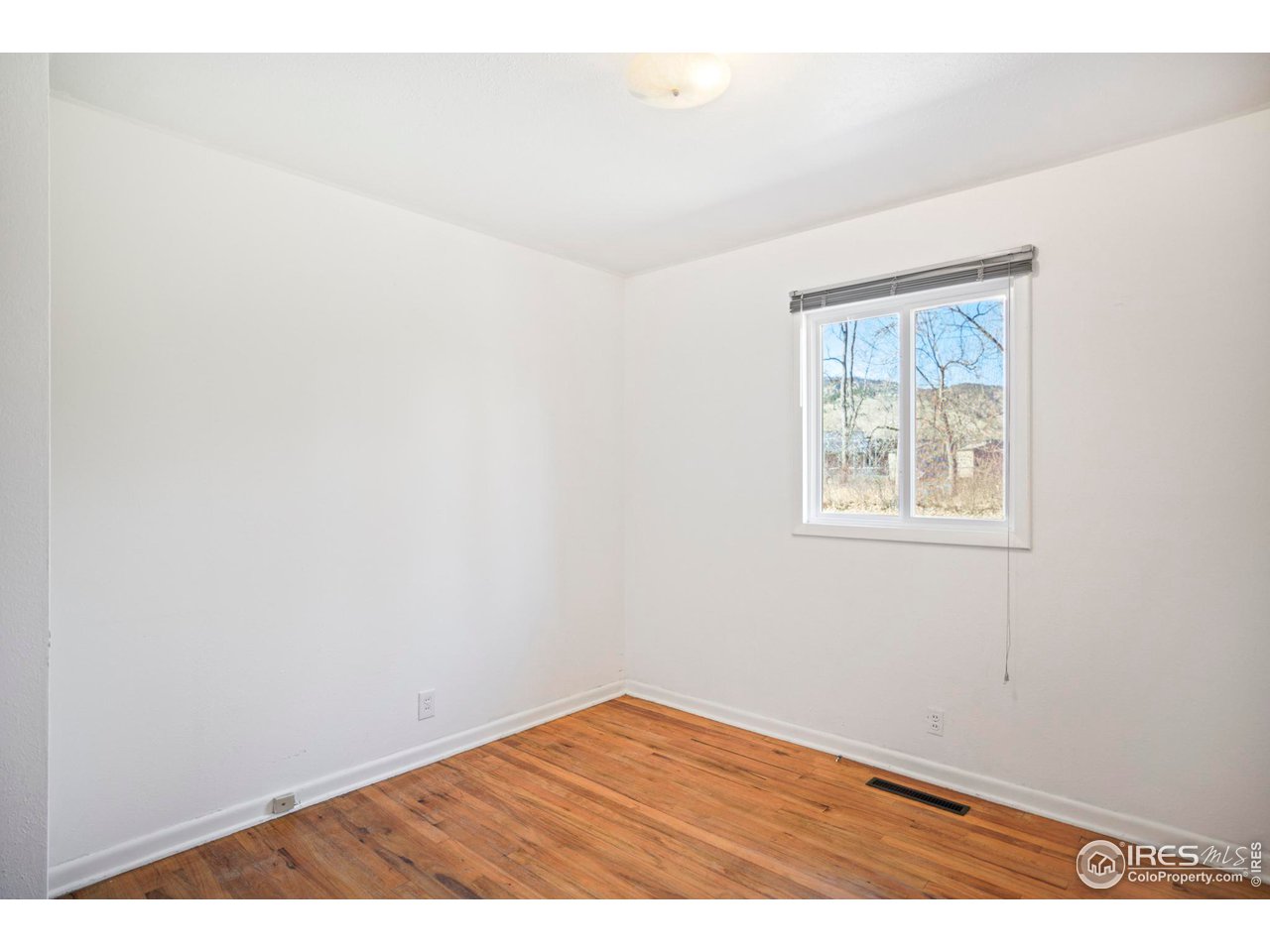 3120 Jefferson Street Boulder, CO 80304 - Photo 14 of 23 an empty room with wooden floor and windows
