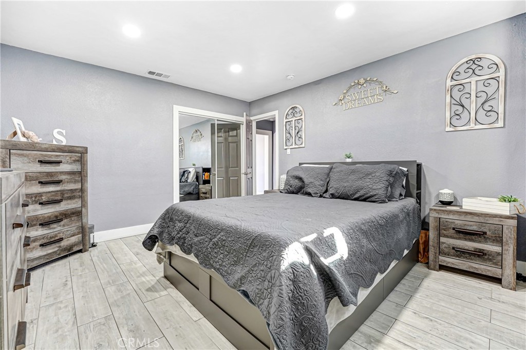 11068 Penrose Street Sun Valley, CA 91352 - Photo 12 of 27 a bedroom with a bed and a walk in closet
