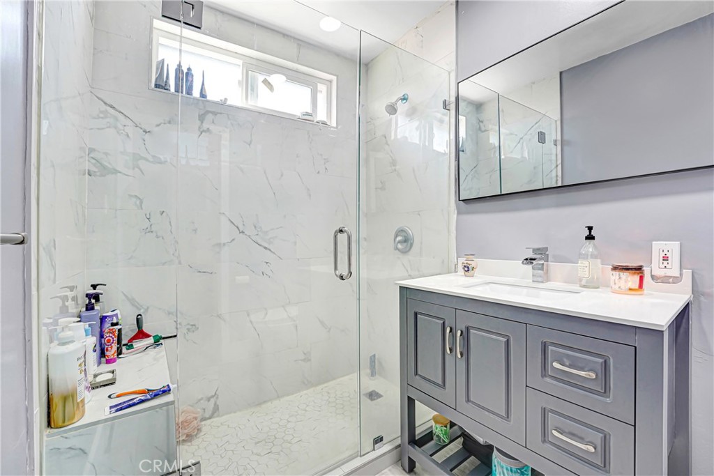 11068 Penrose Street Sun Valley, CA 91352 - Photo 13 of 27 a bathroom with a granite countertop sink a toilet and shower