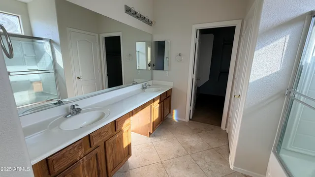 a bathroom with a double vanity sink and mirror