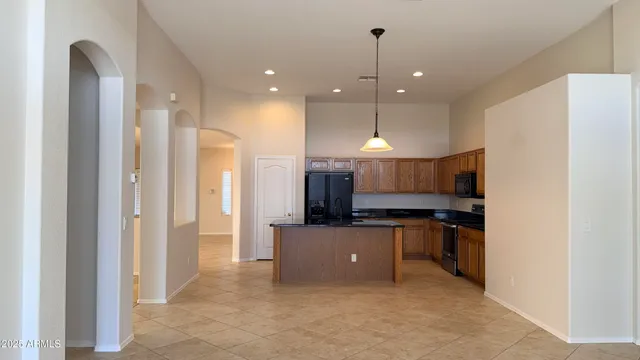 a open kitchen with cabinets and a stainless steel appliances