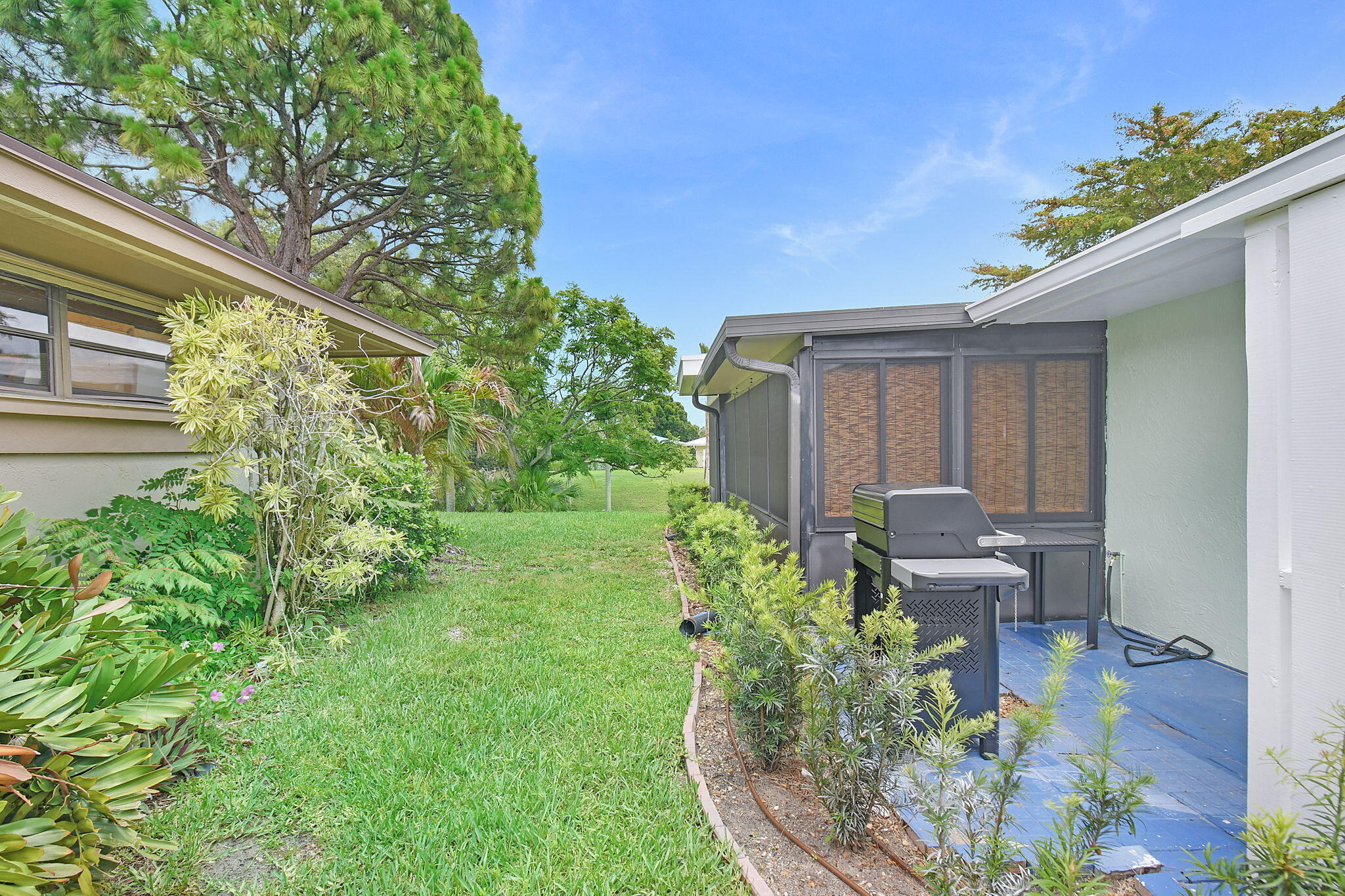 5251 Southeast Sea Island Way Stuart, FL 34997 - Photo 37 of 68 a view of a backyard with plants and a patio