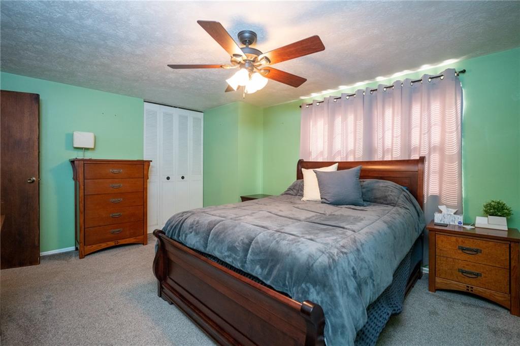 705 Countryside Drive McKees Rocks, PA 15136 - Photo 9 of 25 a bed room with a bed and a dresser